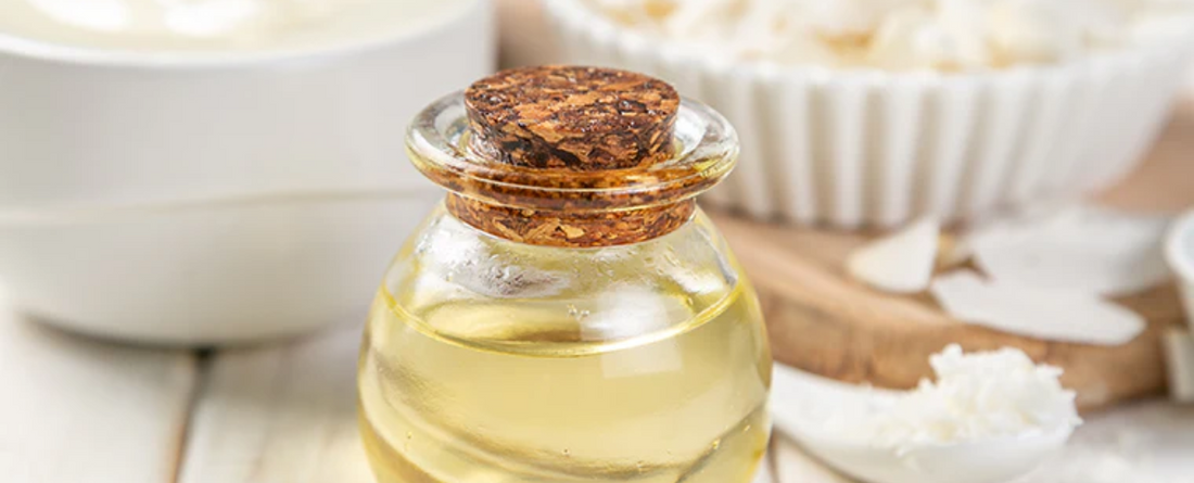 A glass bottle of MCT oil with a cork lid, surrounded by bowls and coconut flakes.