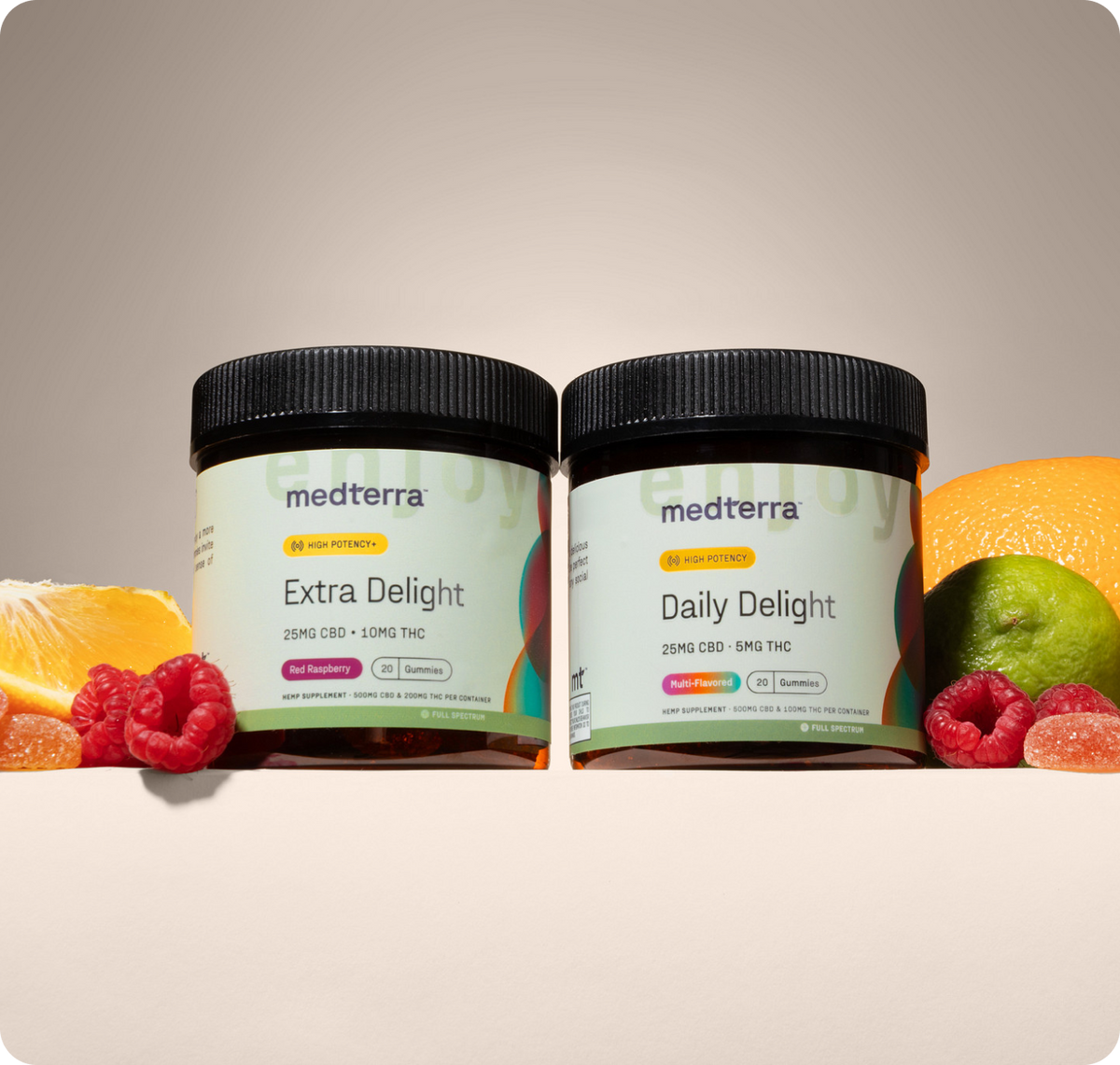 Front view of two Medterra gummy jars, 25 mg CBD/10 mg THC and 25 mg CBD/5 mg THC, with fruit on beige background