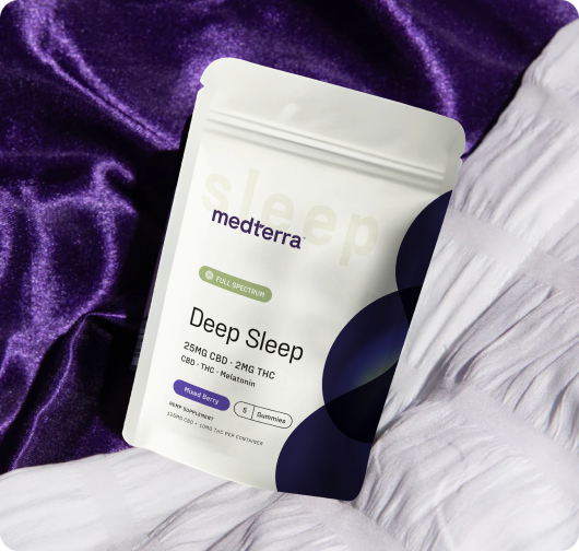 Angled front view of Deep Sleep pouch showcasing 25mg CBD and 2mg THC labeling on purple satin and white quilt