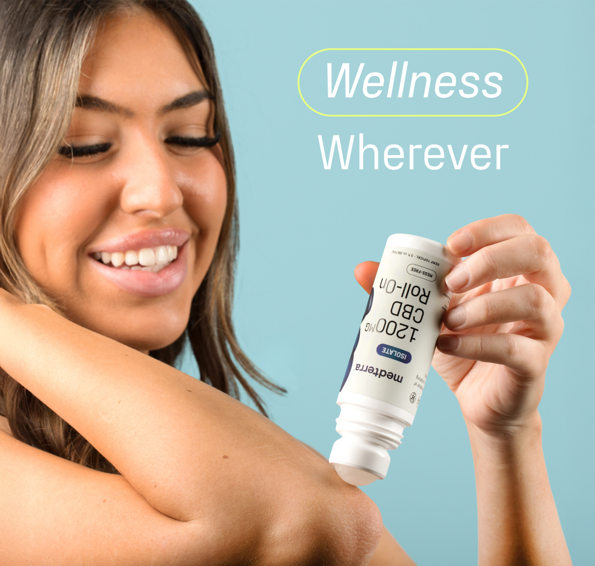 A smiling woman applies Medterra WM: Isolate 1,200mg Roll-On to her elbow, with "Wellness Wherever" beside her on a light blue background.