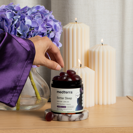 A jar of Medterra Better Sleep TruCBN® Gummies, featuring 50mg CBN and 10mg CBD per gummy in Blackberry Lemonade flavor. This melatonin-free sleep aid includes 20 broad spectrum CBD gummies with a black lid and purple accents.