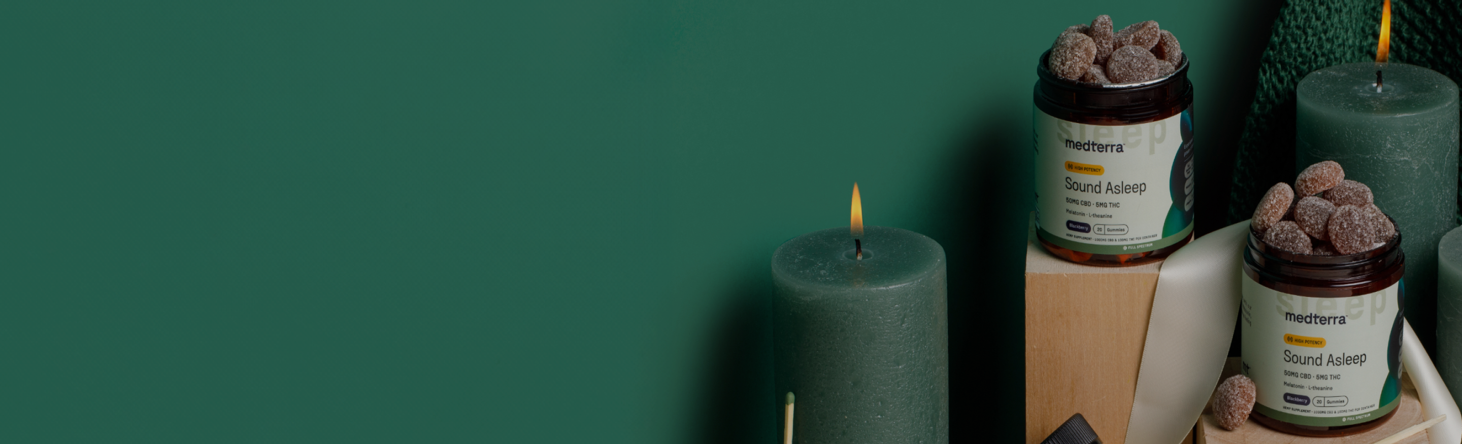 Two jars of Medterra Sound Asleep gummies with lit green candles and a green background.