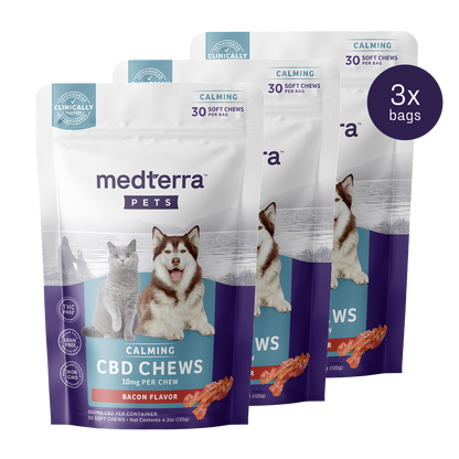 Displayed are three bags of Medterra's Pet CBD Calming Chews, adorned with a cat and dog on bacon-flavored packaging. Each bag contains 30 chews, each with 10mg CBD and L-Tryptophan. A "Clinically Tested" badge is visible in the top left corner, emphasizing quality.